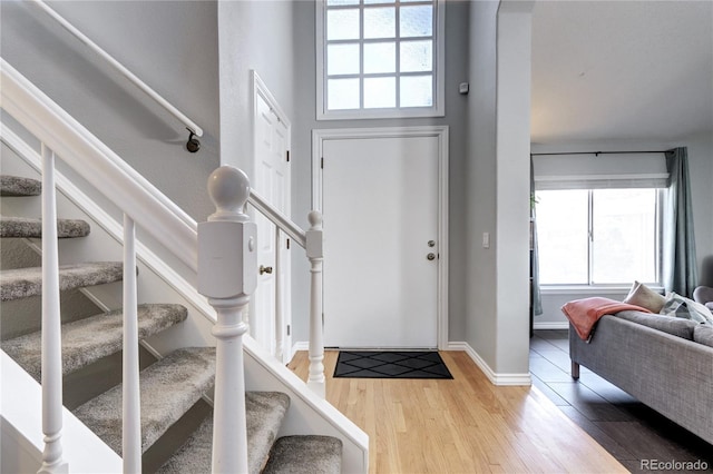 foyer with hardwood / wood-style flooring and a high ceiling