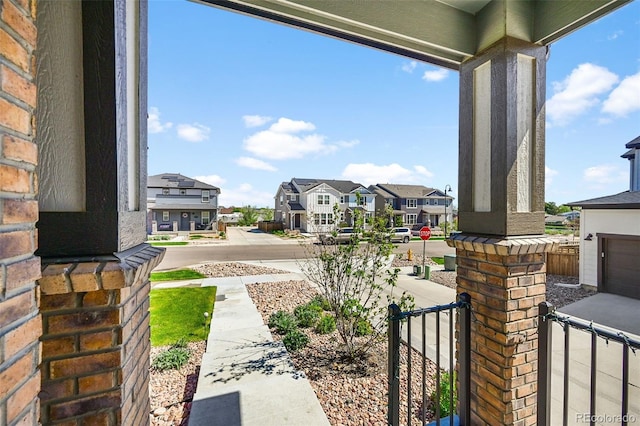 view of yard featuring a porch and a residential view