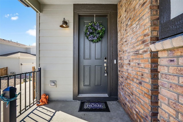 entrance to property with brick siding