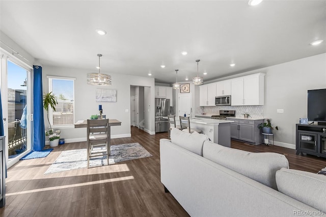 living room featuring baseboards, dark wood-style flooring, and recessed lighting