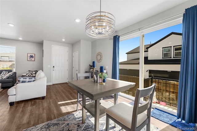 dining space featuring a chandelier, wood finished floors, recessed lighting, and baseboards