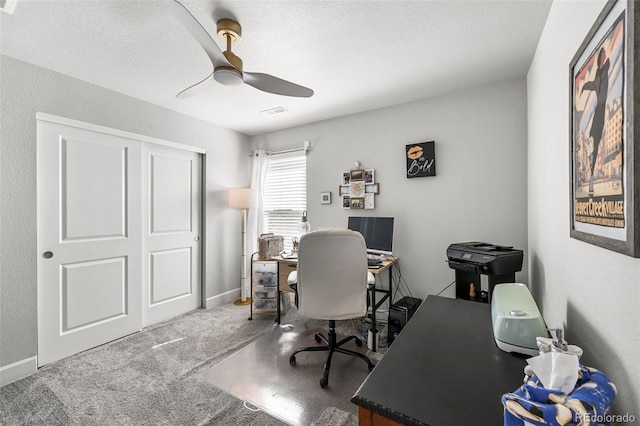 office featuring a ceiling fan, carpet flooring, and a textured ceiling