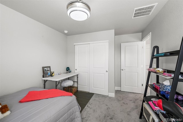 bedroom with a closet, carpet, and baseboards