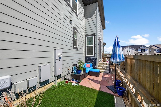 view of property exterior with a fenced backyard and a patio area