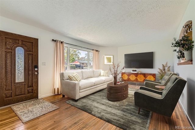 3531 E 91st Ave, Thornton, CO 80229 - living area with a textured ceiling, wood finished floors, and baseboards