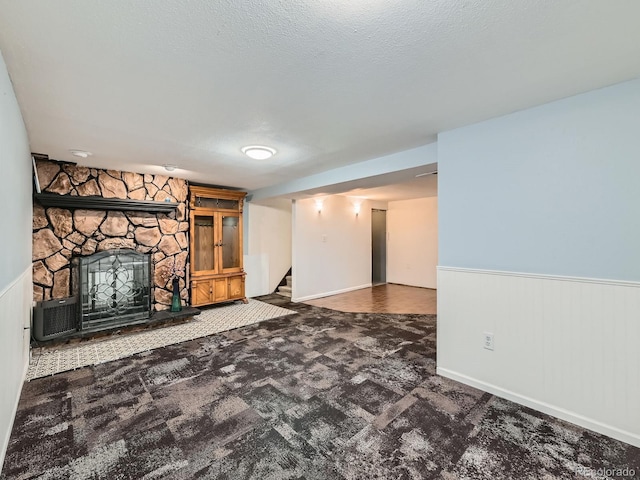 3531 E 91st Ave, Thornton, CO 80229 - unfurnished living room featuring carpet, stairs, wainscoting, and a stone fireplace