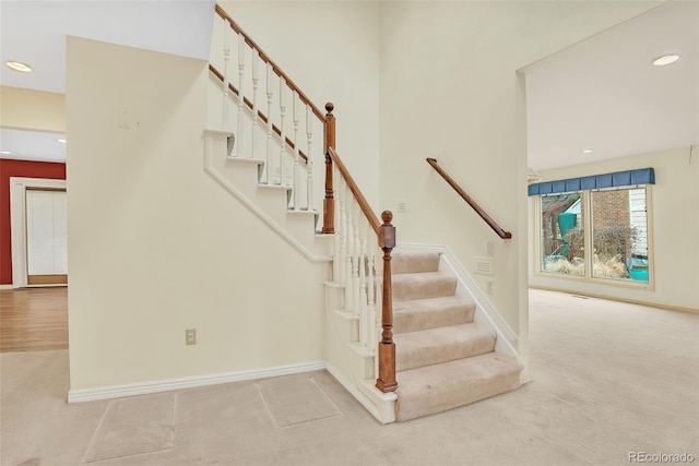 staircase featuring baseboards, carpet flooring, and recessed lighting