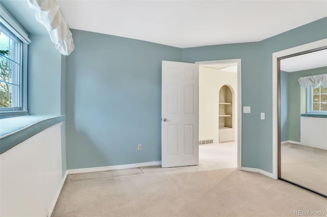 unfurnished bedroom featuring visible vents, baseboards, and carpet flooring