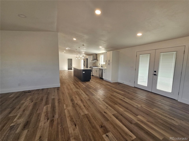 unfurnished living room with french doors, sink, and dark hardwood / wood-style floors