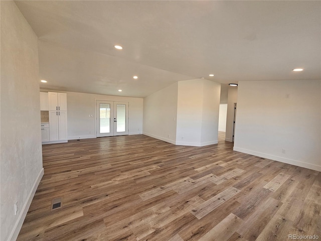 unfurnished room with light hardwood / wood-style flooring and french doors