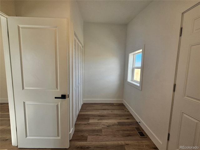 corridor with dark hardwood / wood-style flooring