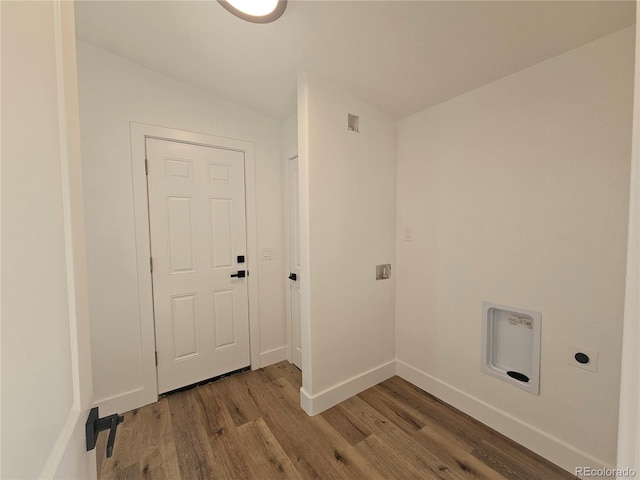 laundry room featuring hardwood / wood-style flooring and electric dryer hookup