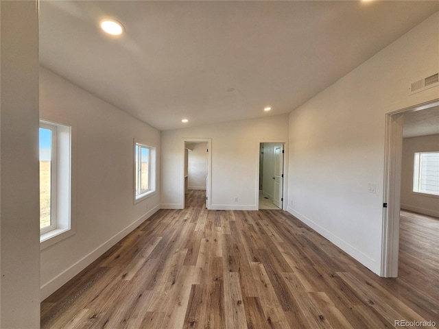 interior space featuring light hardwood / wood-style floors and lofted ceiling