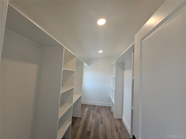 spacious closet featuring light hardwood / wood-style floors