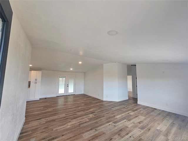 unfurnished living room with french doors and light hardwood / wood-style flooring