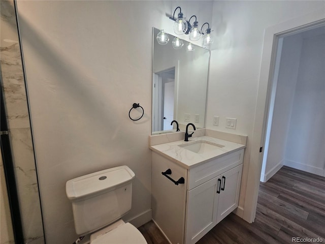 bathroom featuring vanity, hardwood / wood-style floors, and toilet