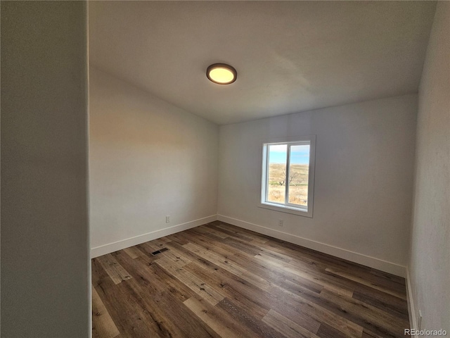 empty room with dark wood-type flooring