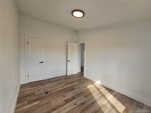 unfurnished room featuring dark wood-type flooring