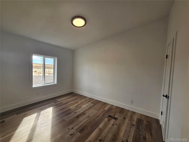 empty room featuring dark wood-type flooring