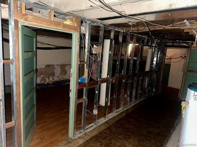 interior space with wood-type flooring and water heater