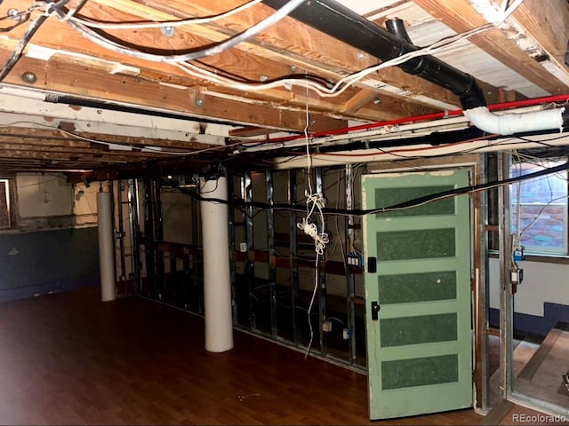 basement with dark hardwood / wood-style flooring