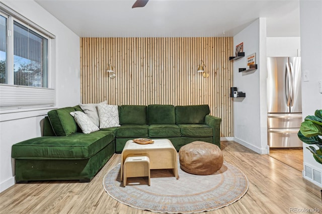 living room featuring ceiling fan and light wood-type flooring