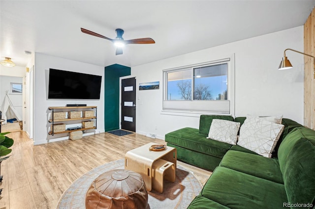 living room featuring ceiling fan and light wood-type flooring