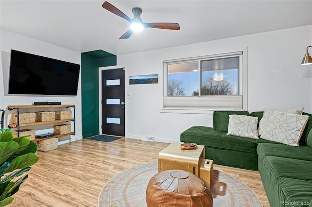 living room featuring ceiling fan and light wood-type flooring