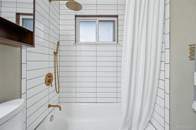 bathroom with toilet and shower / bath combo with shower curtain