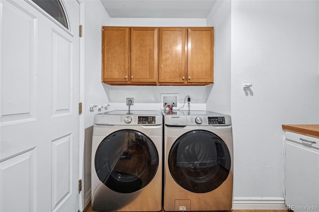 laundry area featuring cabinets and separate washer and dryer