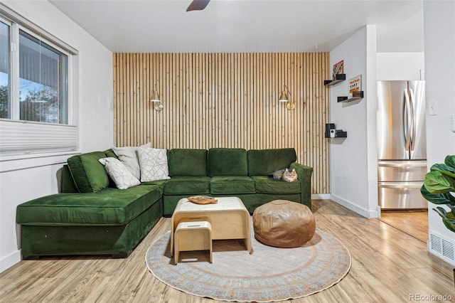 living room featuring light hardwood / wood-style floors and ceiling fan