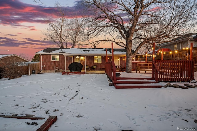 snow covered property featuring a deck