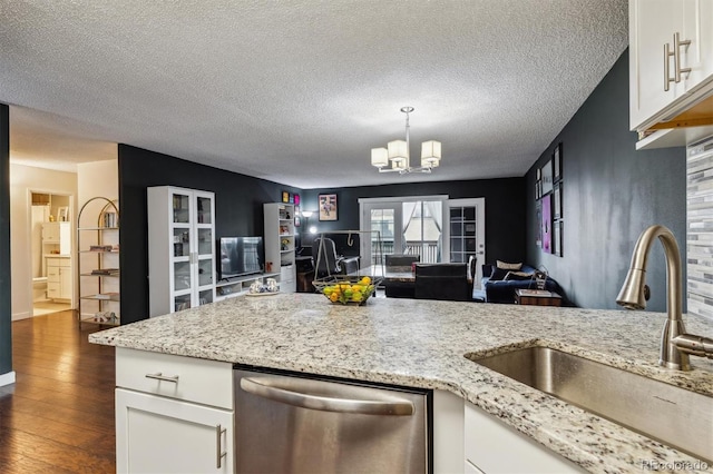 kitchen with dark wood-type flooring, sink, stainless steel dishwasher, white cabinetry, and a textured ceiling