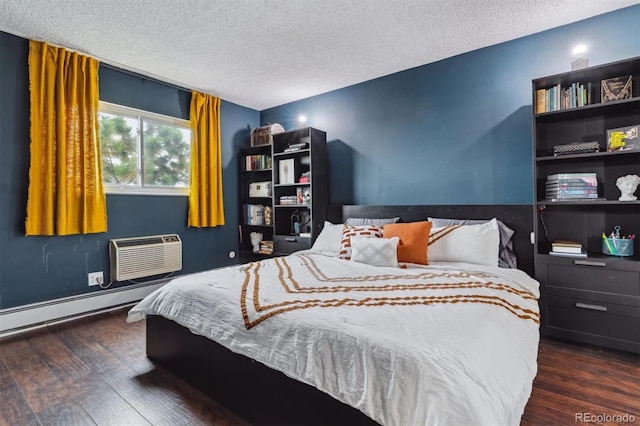 bedroom featuring baseboard heating, a textured ceiling, a wall unit AC, and dark hardwood / wood-style floors