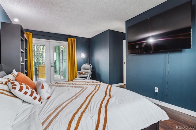 bedroom featuring french doors, access to exterior, a textured ceiling, and dark hardwood / wood-style flooring