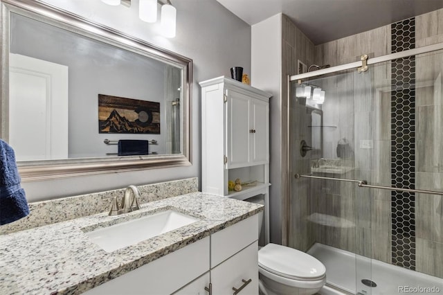 bathroom featuring vanity, toilet, and walk in shower