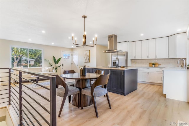 3480 E 119th St, Thornton, CO 80233 - dining area featuring light wood-type flooring, a chandelier, and recessed lighting