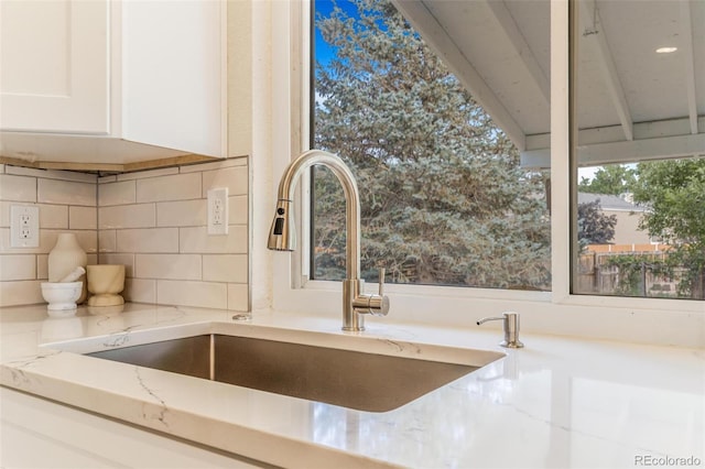 3480 E 119th St, Thornton, CO 80233 - kitchen view of light stone countertops, white cabinets, and tasteful backsplash