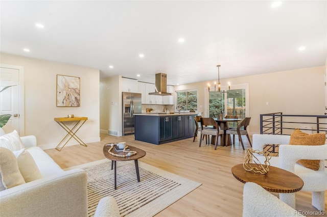 3480 E 119th St, Thornton, CO 80233 - living area with a chandelier, light wood finished floors, and recessed lighting