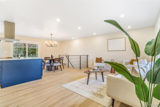 3480 E 119th St, Thornton, CO 80233 - living area with light wood-style flooring, a chandelier, and recessed lighting
