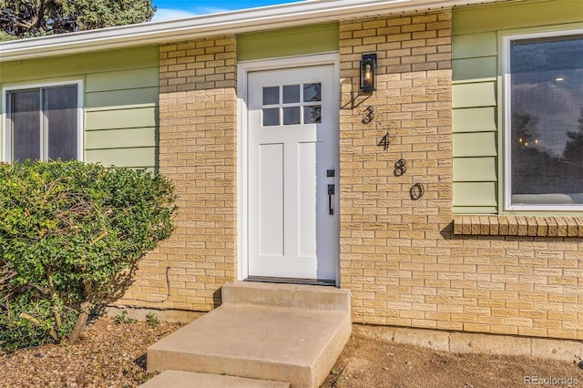 3480 E 119th St, Thornton, CO 80233 - doorway to property featuring brick siding