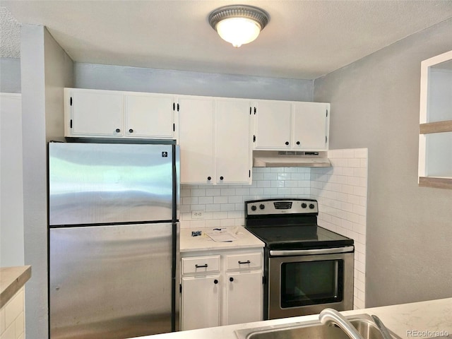 kitchen featuring stainless steel appliances, white cabinets, tasteful backsplash, and sink