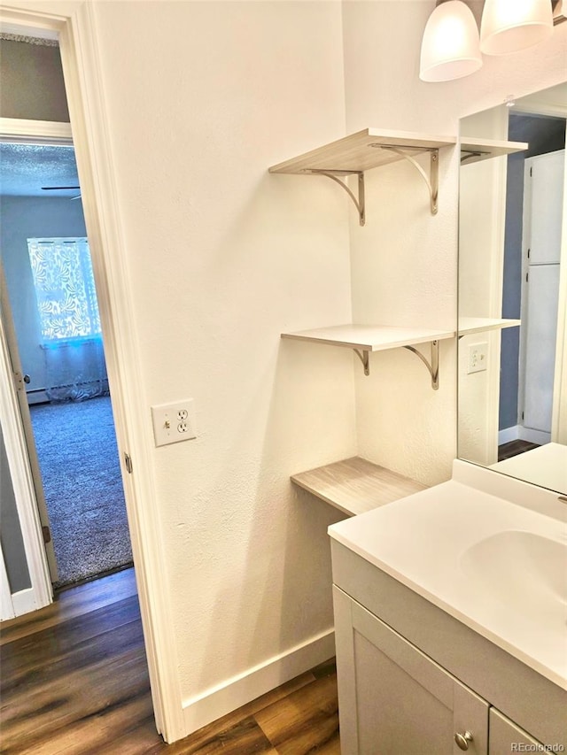 laundry area with dark wood-type flooring and sink