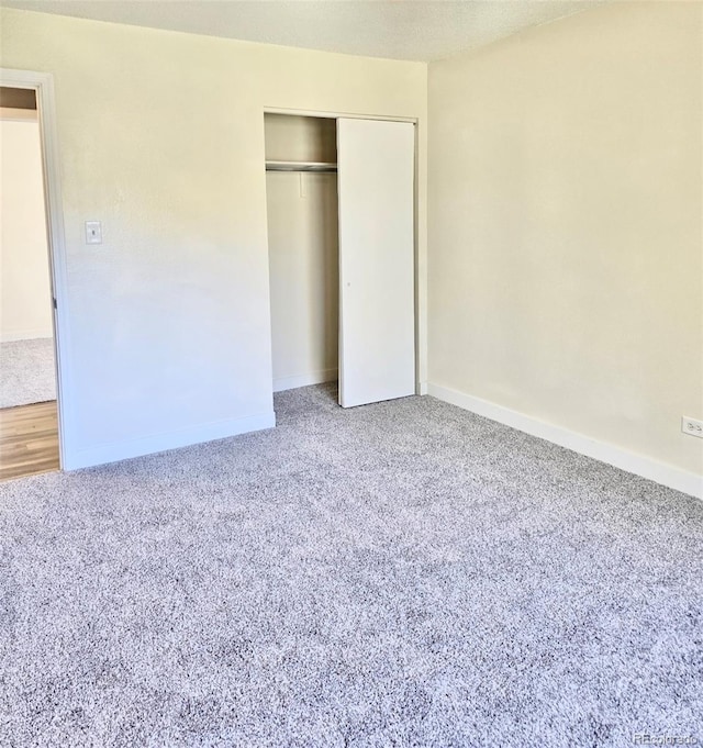 unfurnished bedroom with a closet and carpet