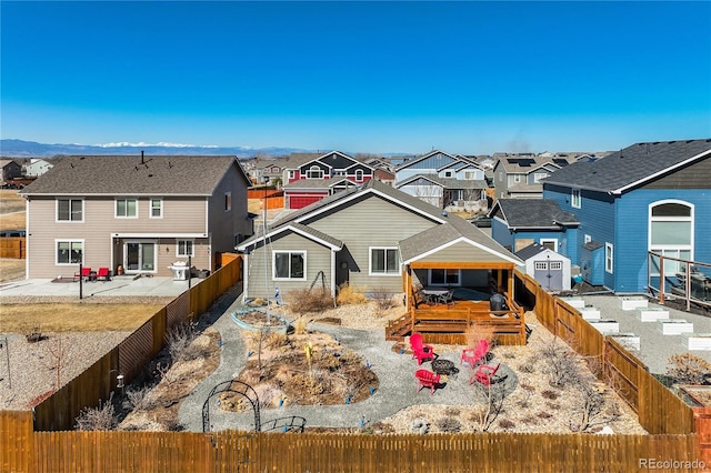 6812 Indian Paintbrush St, Frederick, CO 80530 - rear view of property with a residential view, a fenced backyard, a patio, and a wooden deck