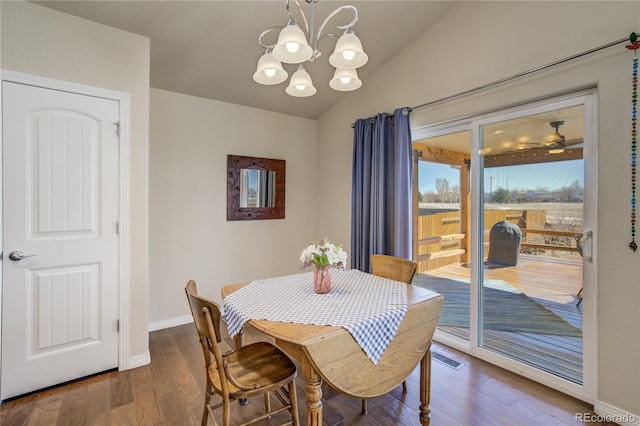 6812 Indian Paintbrush St, Frederick, CO 80530 - dining room with a chandelier, wood finished floors, baseboards, and vaulted ceiling