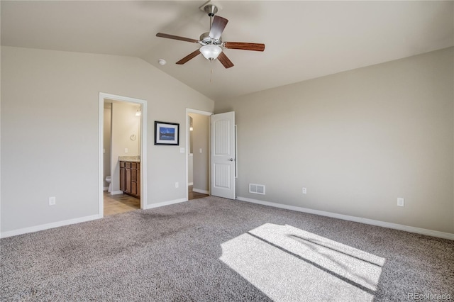6812 Indian Paintbrush St, Frederick, CO 80530 - unfurnished bedroom featuring light carpet, lofted ceiling, baseboards, connected bathroom, and a ceiling fan
