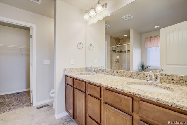 6812 Indian Paintbrush St, Frederick, CO 80530 - bathroom with a shower stall, toilet, double vanity, and baseboards