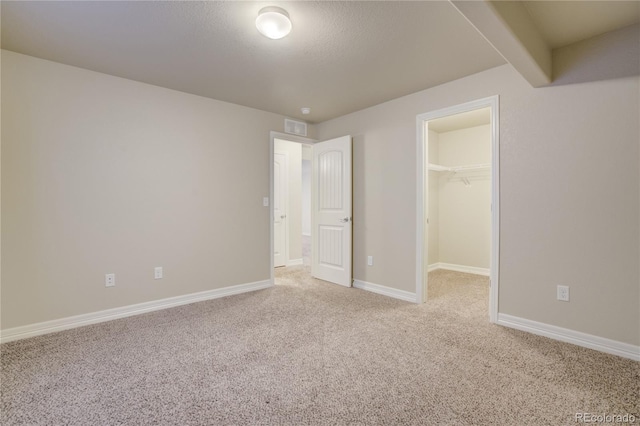 6812 Indian Paintbrush St, Frederick, CO 80530 - unfurnished bedroom featuring carpet flooring, a walk in closet, baseboards, and a closet
