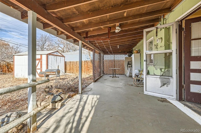 view of patio featuring a storage unit